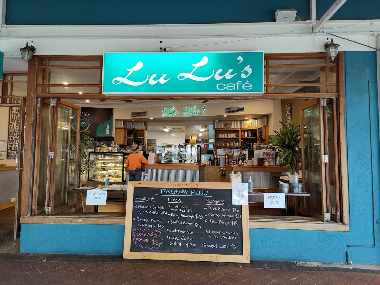 The Lu Lu's Cafe shopfront with its teal sign and takeaway menu board on Rockingham Beach Road